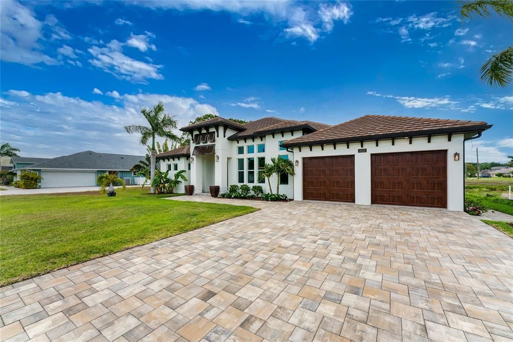 An extra wide paver driveway provides ample guest parking.