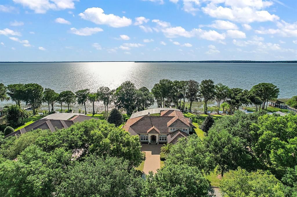 Lake Harris-Chain of Lakes custom estate pool home with boathouse on 1 acre in a private gated community