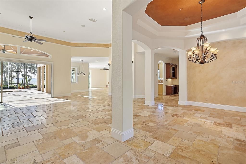 This luxury home features a palatial interior with high custom-trimmed tray ceilings, wide crown molding, and baseboards