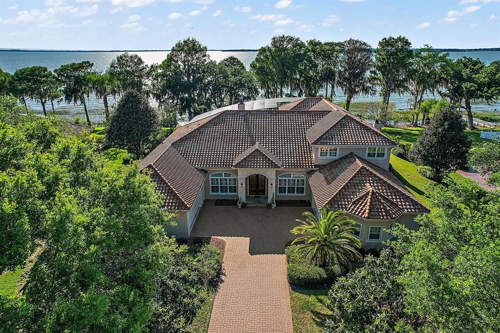 The grand architecture, complete with cast stone details, tile roof, and covered front entry