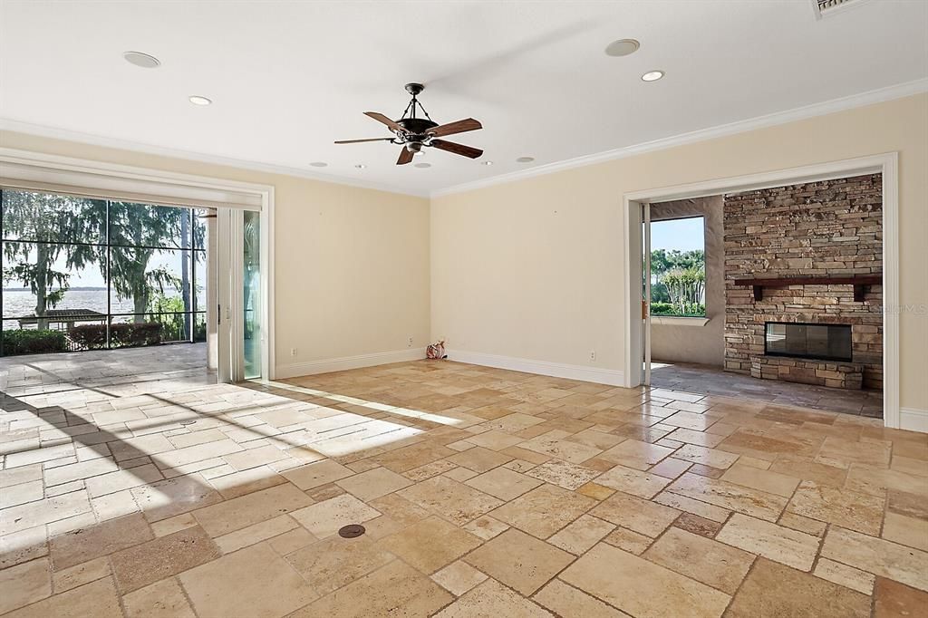 Open to the kitchen is the family room  and a glass slider to lanai for lake views year round