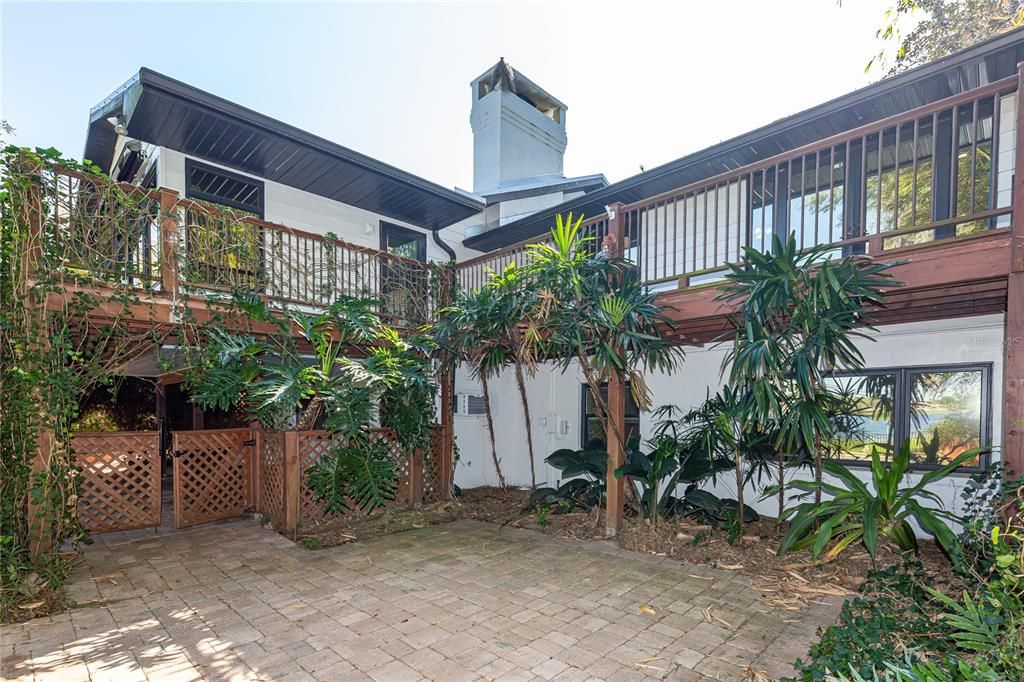 Private pool patio area with gate to lanai and upper level wrap-around decks