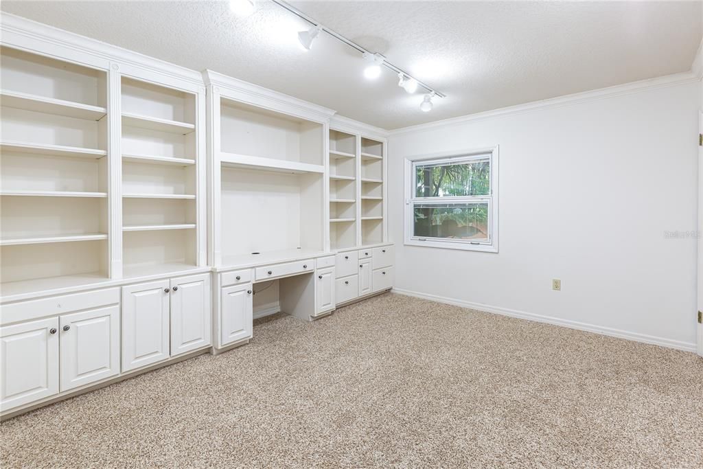 Lower level guest bedroom with built-in storage and two closets