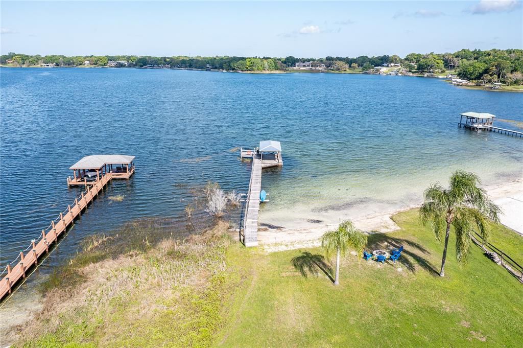 Boat house and dock with white sand beach