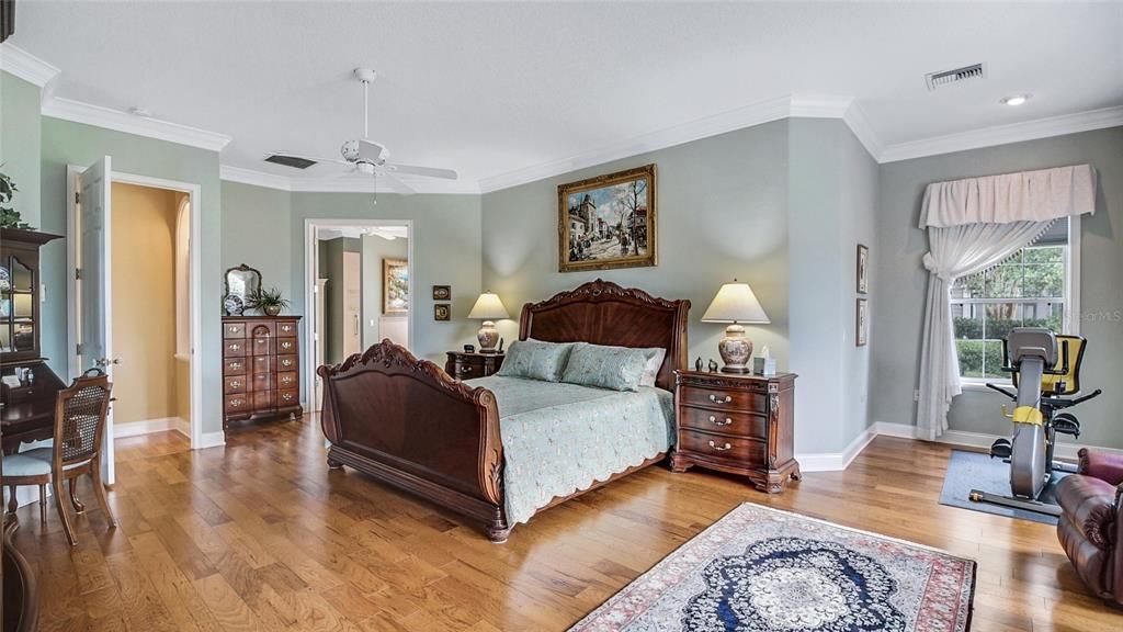 Beautiful bamboo flooring and crown molding accentuate this spacious master suite.