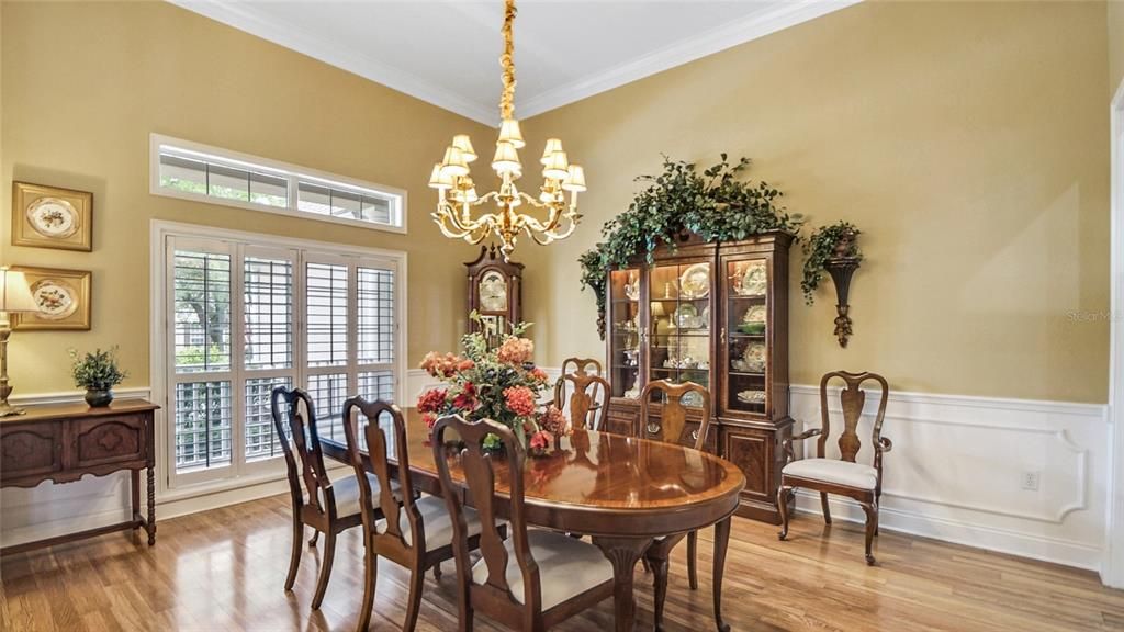 Plantation shutters and transoms provide privacy as well as beautiful natural lighting. And notice the detailed wainscoting and crown molding.