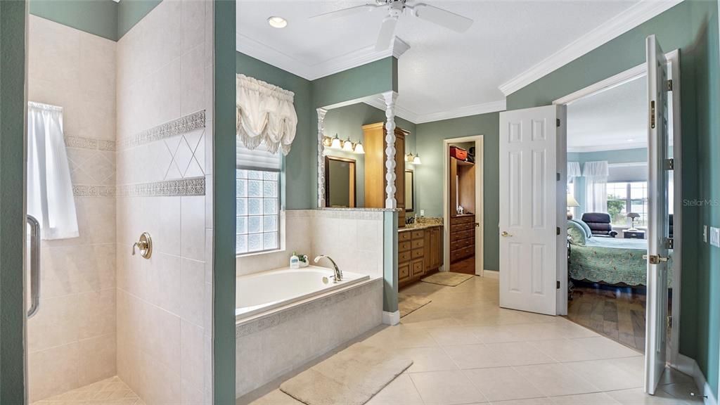 The luxurious ensuite offers a jetted tub and large walk-in shower with a sitting bench as well as dual custom closets.