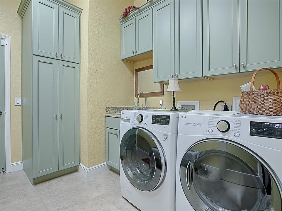 THIS LAUNDRY ROOM IS 4 TIMES THE SIZE OF THE ORIGINAL WITH BUILT-IN SINK, EXTRA CABINETRY, SUPPLY CLOSET AND FRONT LOAD WASHER AND DRYER (THEY DO CONVEY WITH THE HOME).