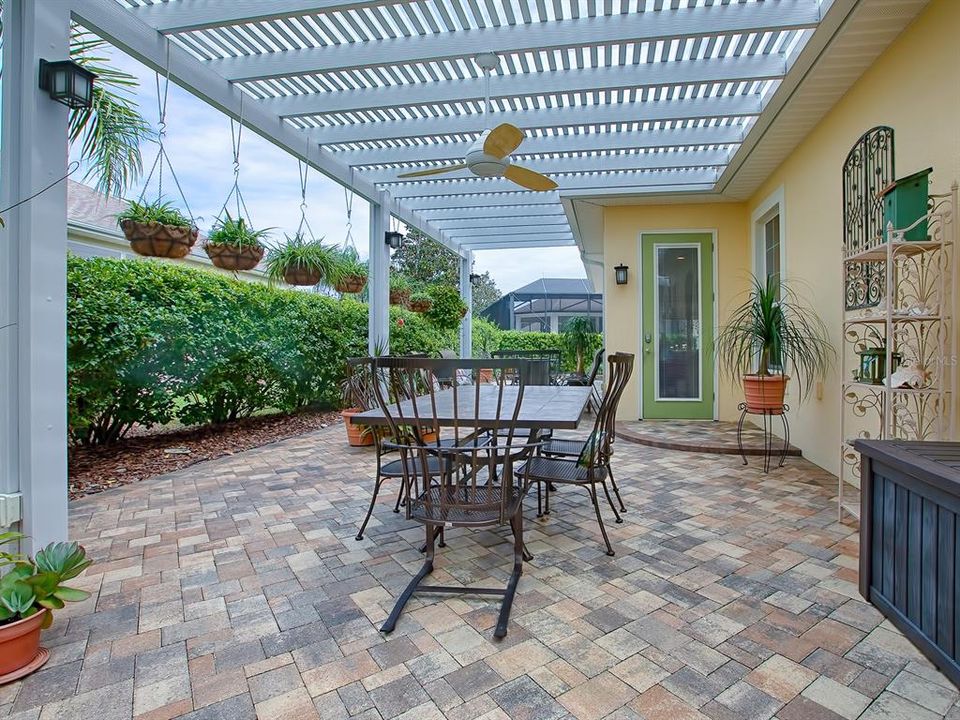 LET'S STEP OUTSIDE FROM THE FLORIDA ROOM!  IMPRESSIVE PERGOLA AND VERY ATTRACTIVE PAVERED OUTDOOR LIVING SPACE!