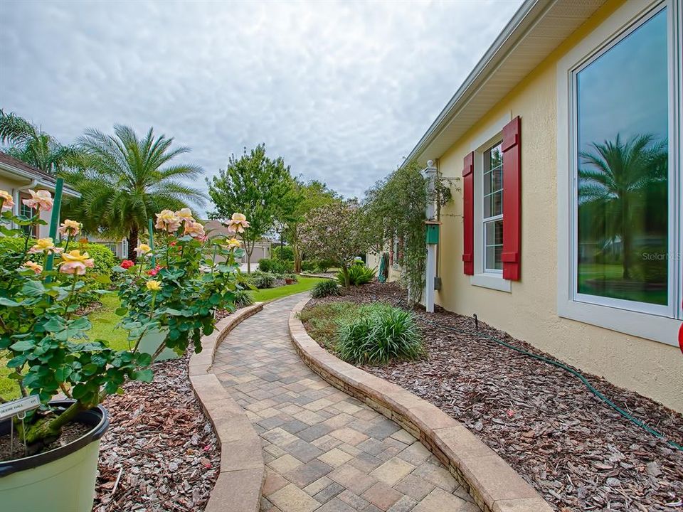 YOUR WALKWAY ON THE LEFT SIDE OF THE HOUSE! LOVELY LANDSCAPING AROUND THE ENTIRE HOME!
