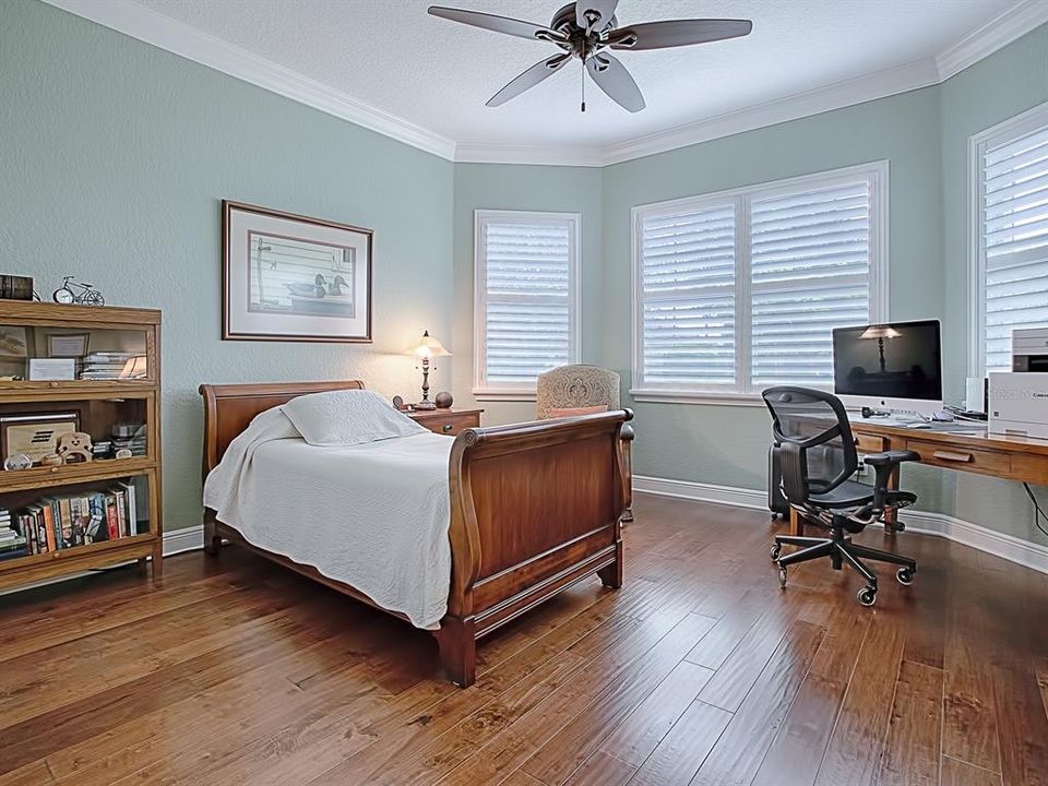 BACK TO THE FRONT OF THE HOME WITH AN EXPANDED 17 X 14 FRONT GUEST ROOM WITH BAY WINDOW, THE SAME GORGEOUS HARDWOOD FLOORING, CROWN MOLDING AND SHUTTERS!