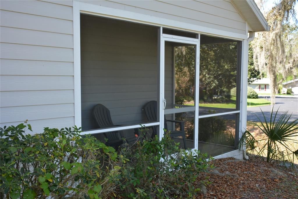 Screened porch provides access to the yard and is accessible from both bedrooms