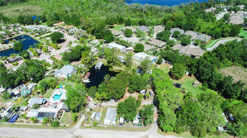 Aerial view of Riverboat Resort, including Lake, pool, house, steel buildings.  Extends from the left heavy tree area to road to far right.  and to the 2 steel buildings in the middle. 4.82 acres MOL
