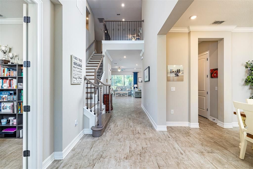 Bright and airy entryway has dedicated office to the left and formal dining room on the right.
