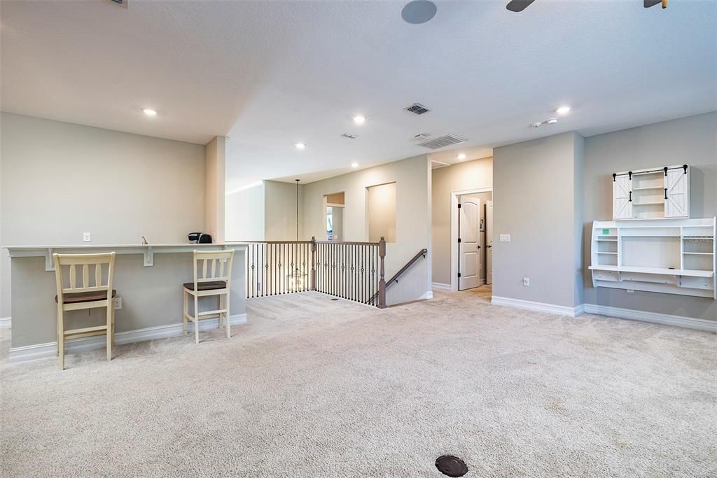 At the top of the stairs is a large bonus room with bar.