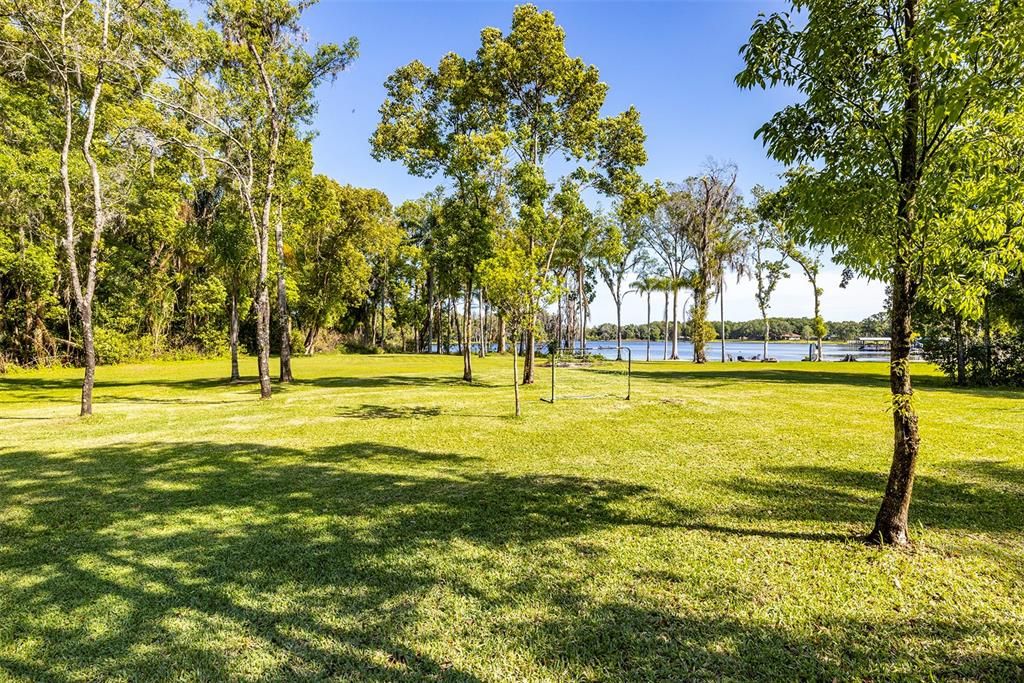 An expansive backyard is ideal for all sorts of games and the property extends well to the left into the trees.