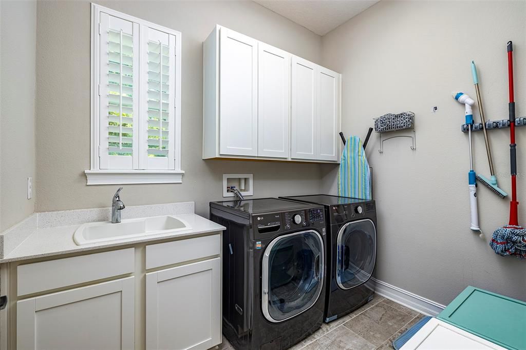 Laundry room with additional storage and sink.
