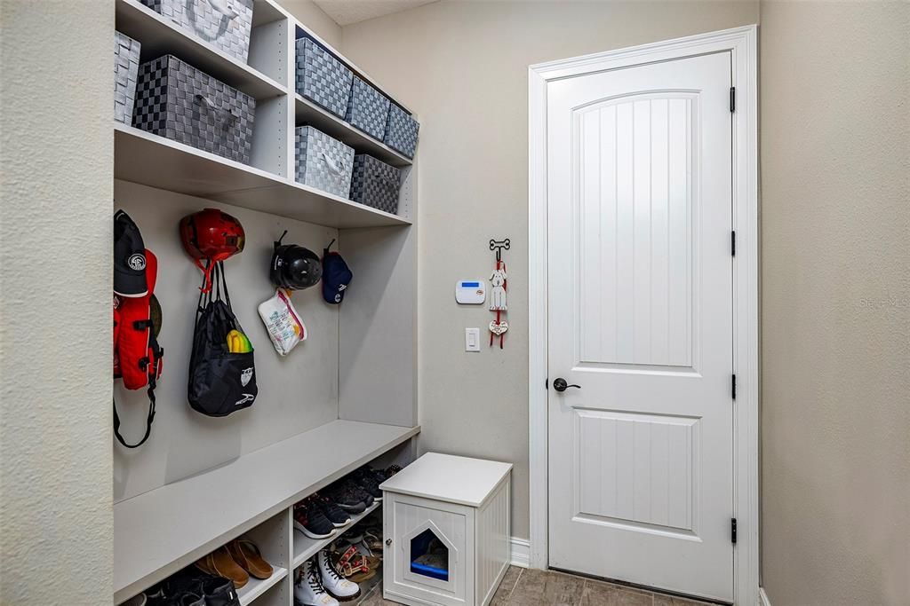 Mudroom has lots of storage and leads to the 3-car garage.