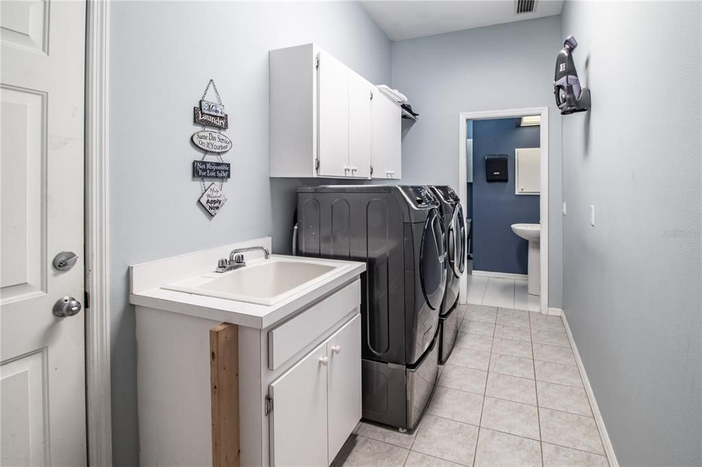 Laundry Room with utility sink and full pool bath in background.