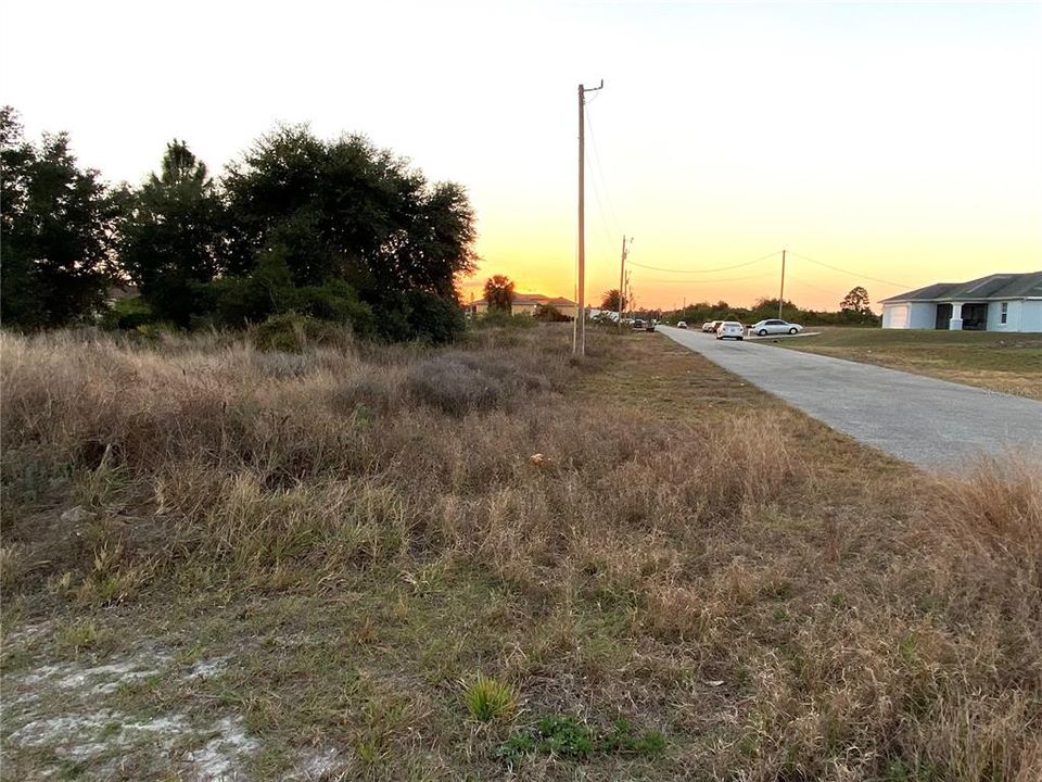 Side View of Lot.  Photo taken from Canal Side, showing end of Street, Lot, and then moving down the street - away from Lot