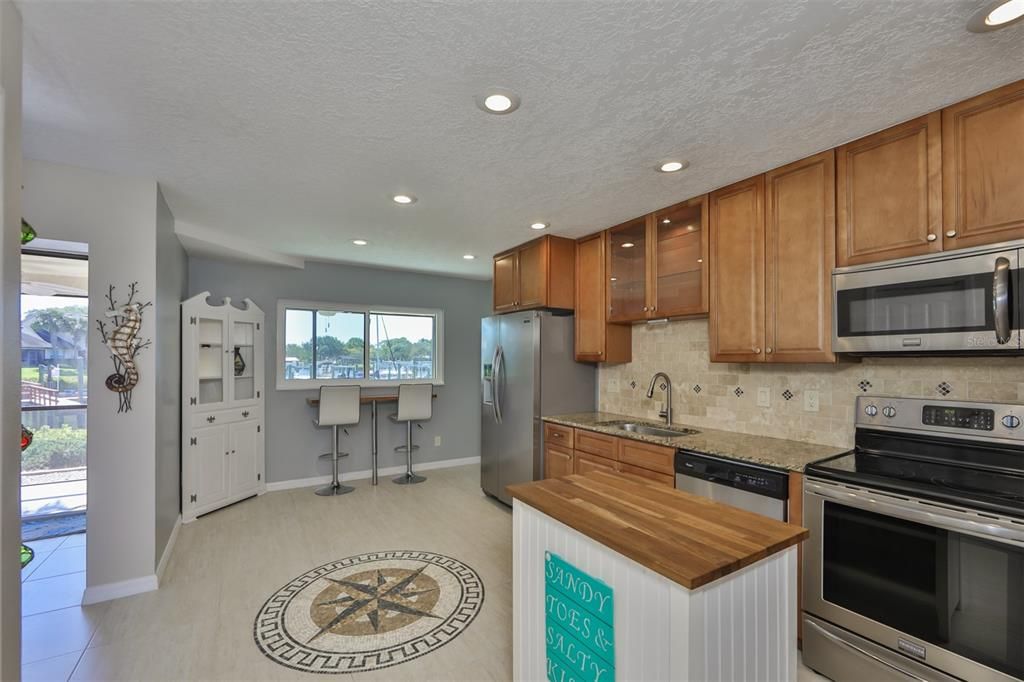 Fully renovated and upgraded kitchen is a joy to work in, when you have a water view like this one.  All wood cabinets, recessed lighting and granite counters are just the beginning.