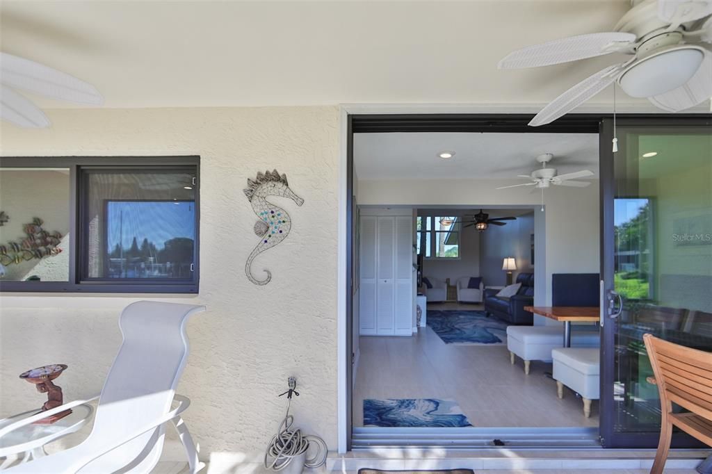 Downstairs screened lanai view looking into the living/dining room areas