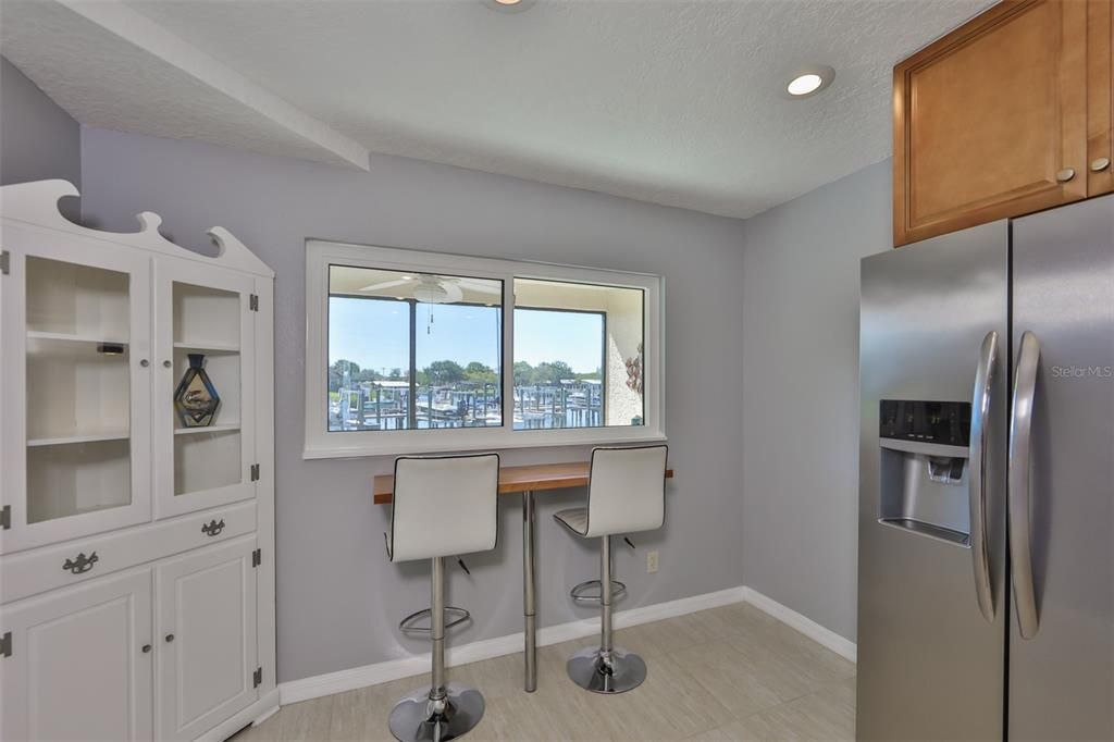 Notice the new IMPACT RESISTENT WINDOWS, which allow unobstructed view of the water, dock and boats.  This Dining/seating nook overlooking the canal from the kitchen for those romantic evenings are just the ticket for a relaxed lifestyle.