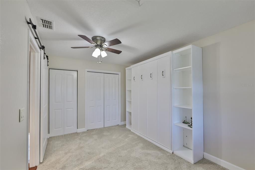 A pull down Queen size Murphy bed is ready for guests, along with two closets for storage.