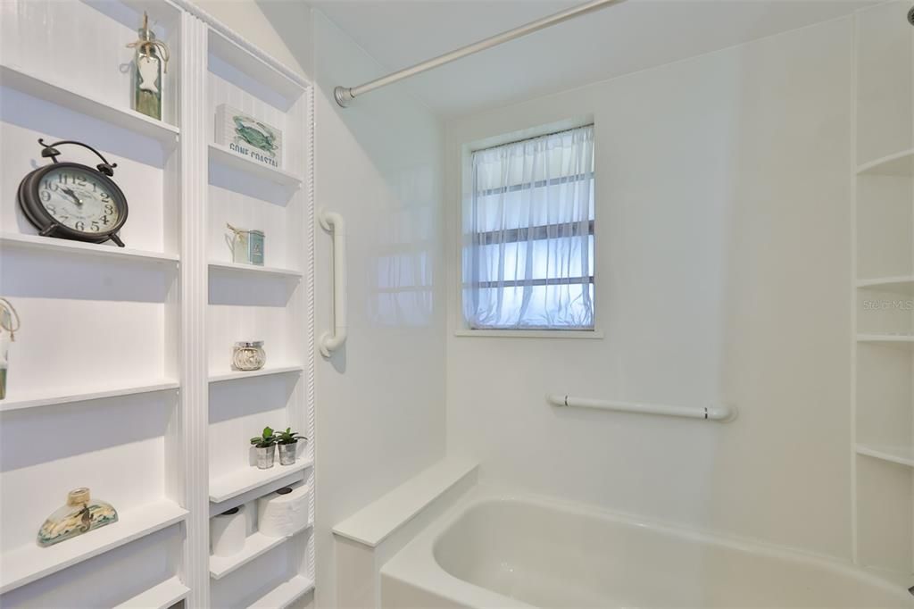 Built-in bathroom wall shelving allow for additional storage and makes for more space in the room.