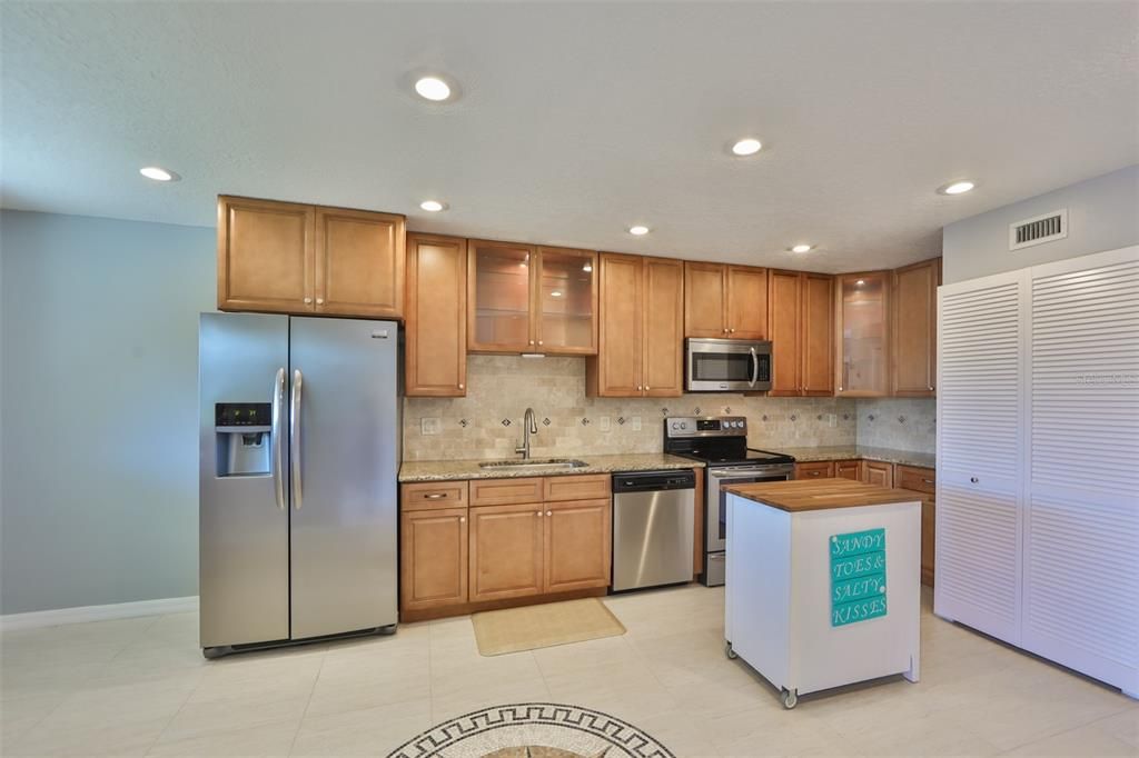 Well coordinated, with neutral tones, this kitchen is easy on the soul.  NOTE the interior is freshly painted in soft tans, grey blue and ultra white colors.  The washer and dryer are located behind the louvered doors to the right.