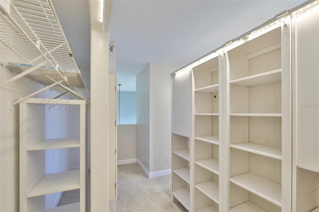 Tons of shelving and closet space means that you don't need additional furniture in the bedroom.