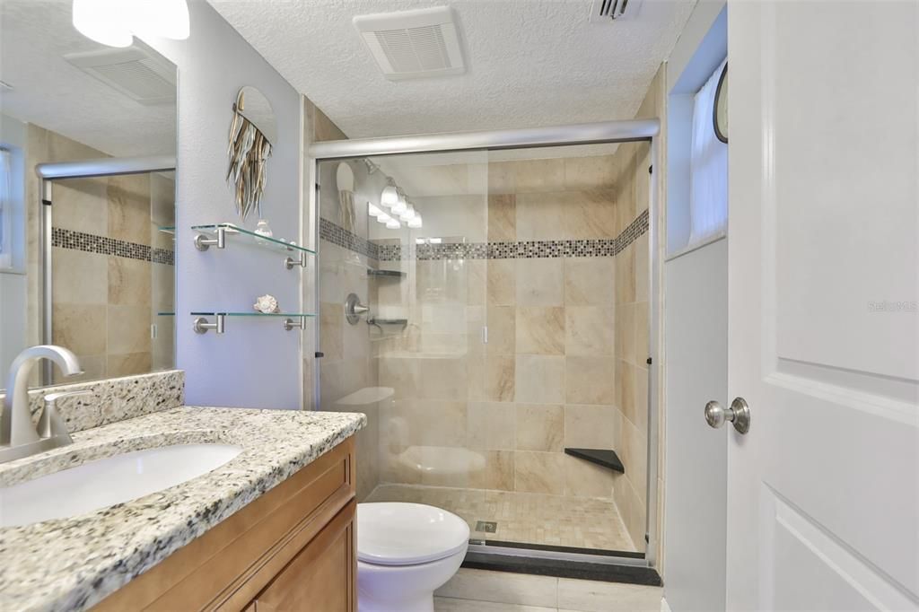 Downstairs bathroom is fully updated with granite counters and tiled showers with ledges.