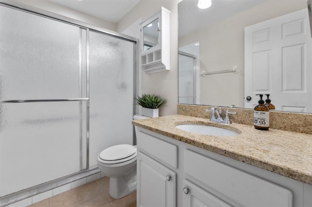 Primary Bathroom With granite counter tops