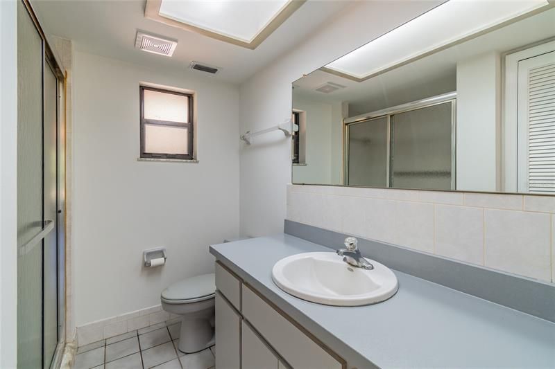 Master Bath has large vanity and step in shower