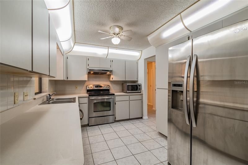 Lots of counter space, light and bright kitchen with passthrough window to sun porch has lots of cabinets and newer stainless steel appliances.