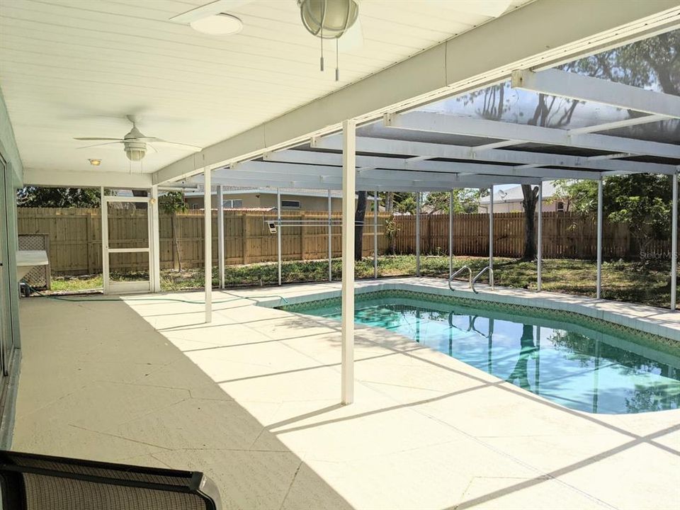 Caged pool has pass- through window from Kitchen