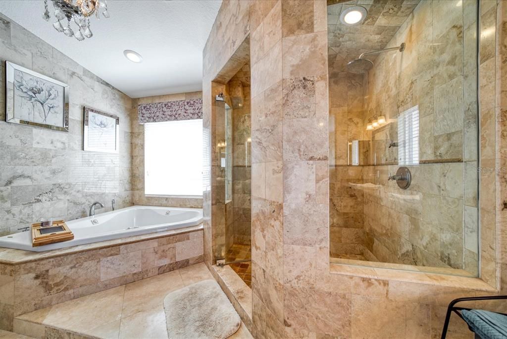 Luxurious tub with separate shower.