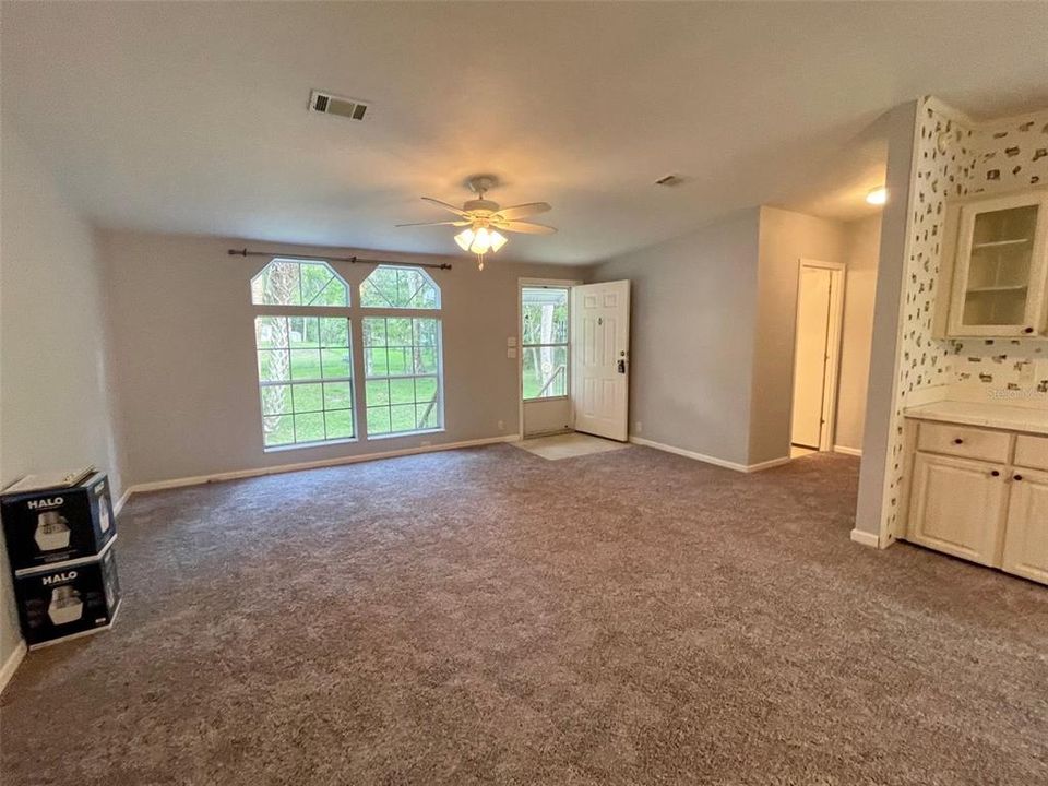 Great room... high ceilings, newly installed carpeting in living areas and the bedrooms. The 2 boxes shown here have 2 new exterior lights being installed by the electrician in 2 weeks.