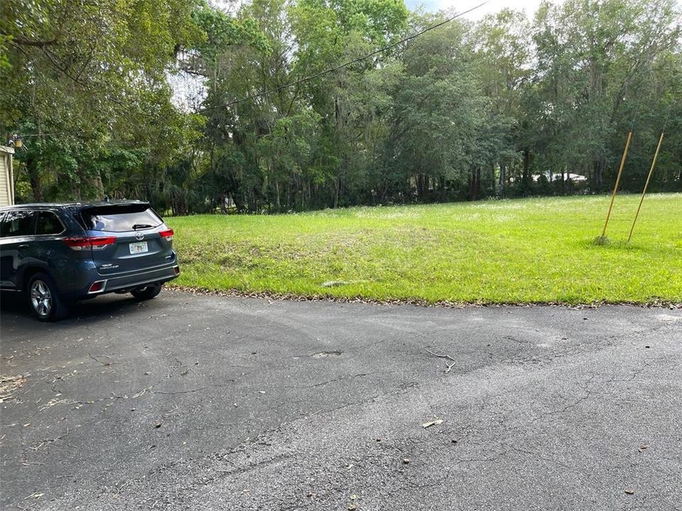 Septic tank for this property is just past the vehicle. This is an extra lot on the right of the property, The seller's family is selling this vacant lot for $15,000 and is approx 1/4 of an acre.