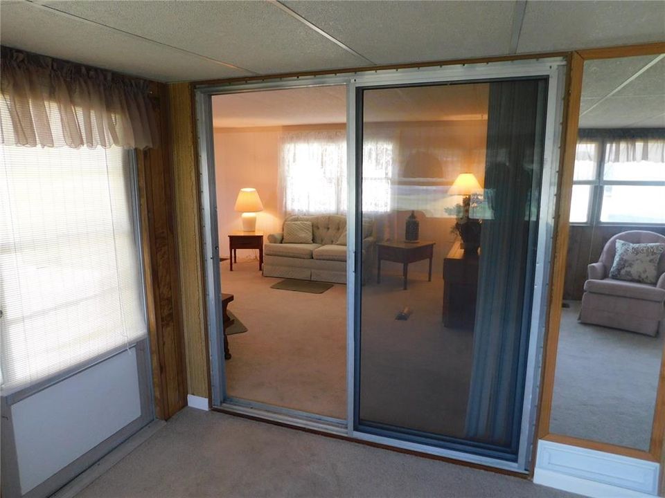 Sliding glass door into Florida room which heating and cooled on central system.