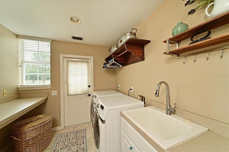 Laundry room with access outside near the garage.