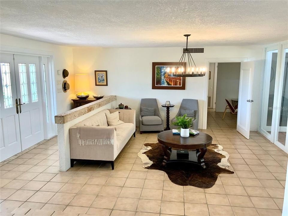 Foyer with stone wall divider that leads you into a comfortable living room area