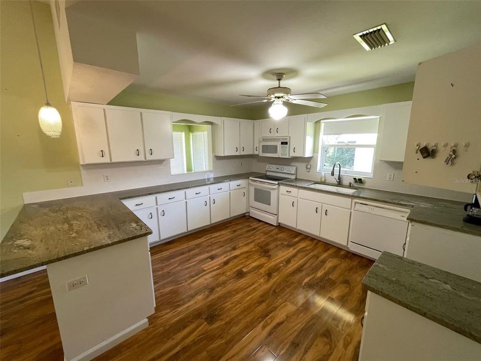 Kitchen w/ pass thru to Florida room. Loads of cabinets and counter space!
