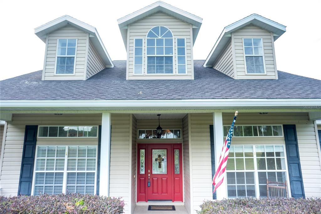 Close up of the front entry & porch. The Dormers & transom windows bring in lots of light.