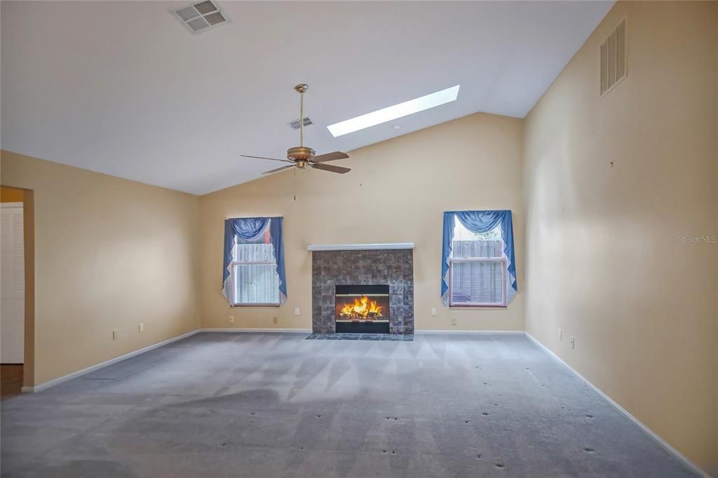 Skylight and decorative stone fireplace with mantle and hearth. Plenty of natural light.