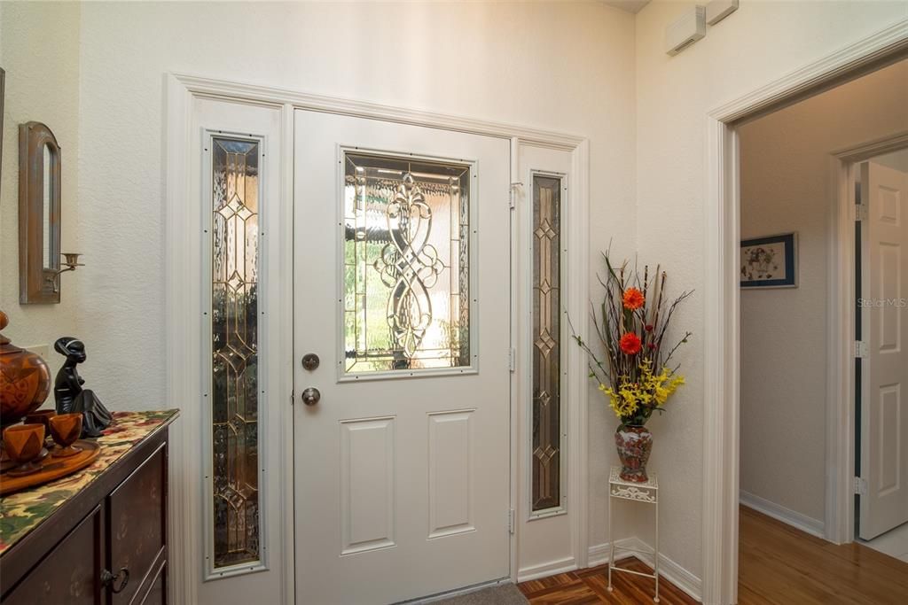 The decorative glass windows in the front door and sidelights provide great natual light to the foyer.