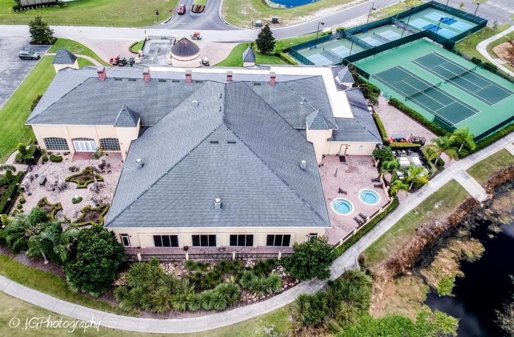 The indoor pool dominates the rear of the Health and Fitness Center. 4 lighted pickleball courts and 2 tennis courts are on the grounds. The spa patio is on the right and the rose garden is on the left of the pool building.
