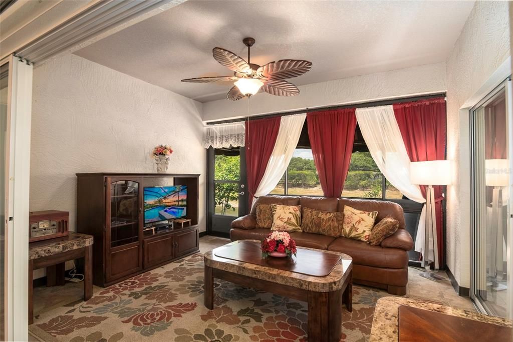 The covered and enclosed lanai is bonus space and is currently used as the TV room.