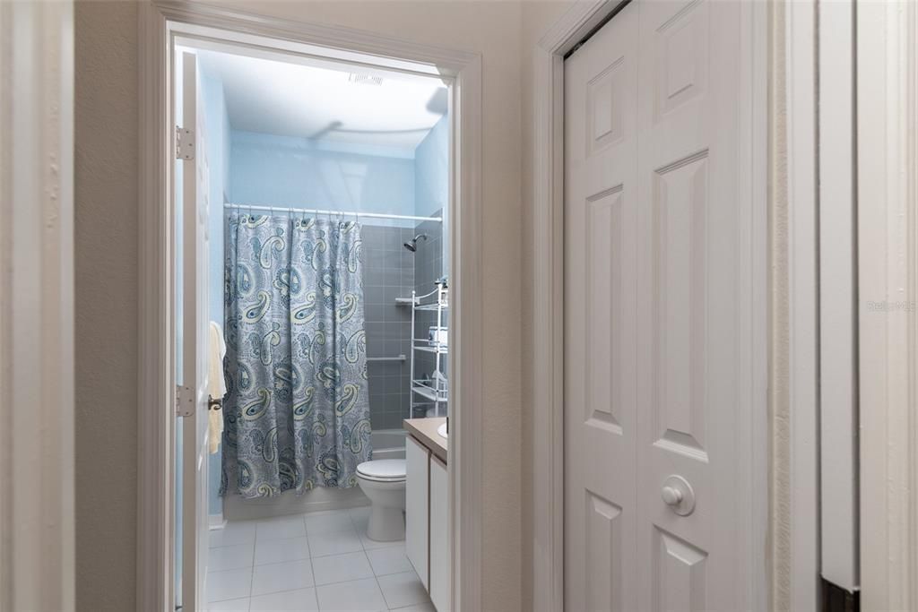 A linen closet is in the hallway that connects the guest bedroom with the guest bath.