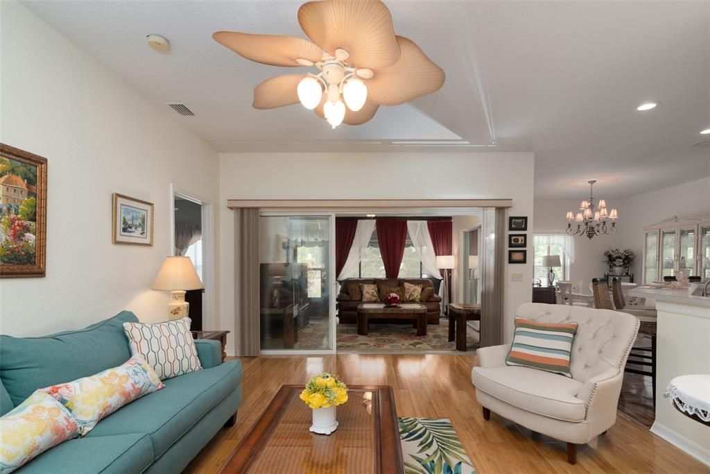 The new bamboo flooring and designer ceiling fan with light add class to the living room.